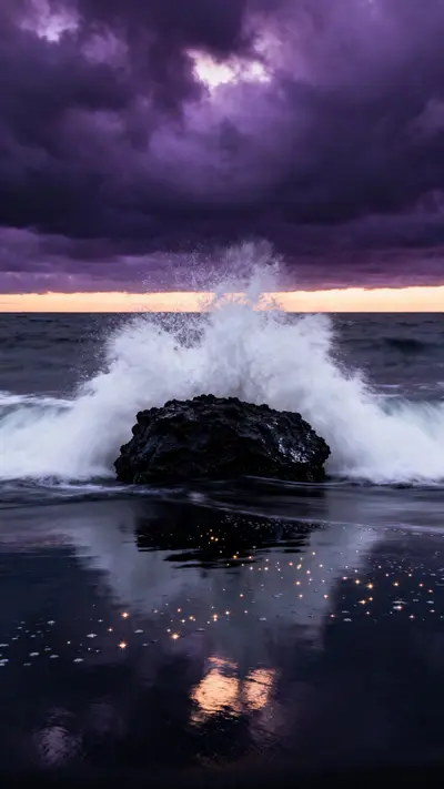 Long-exposure dusk photo of a wave crashing on dark volcanic rock with white water burst, purple storm clouds, and amber horizon glow